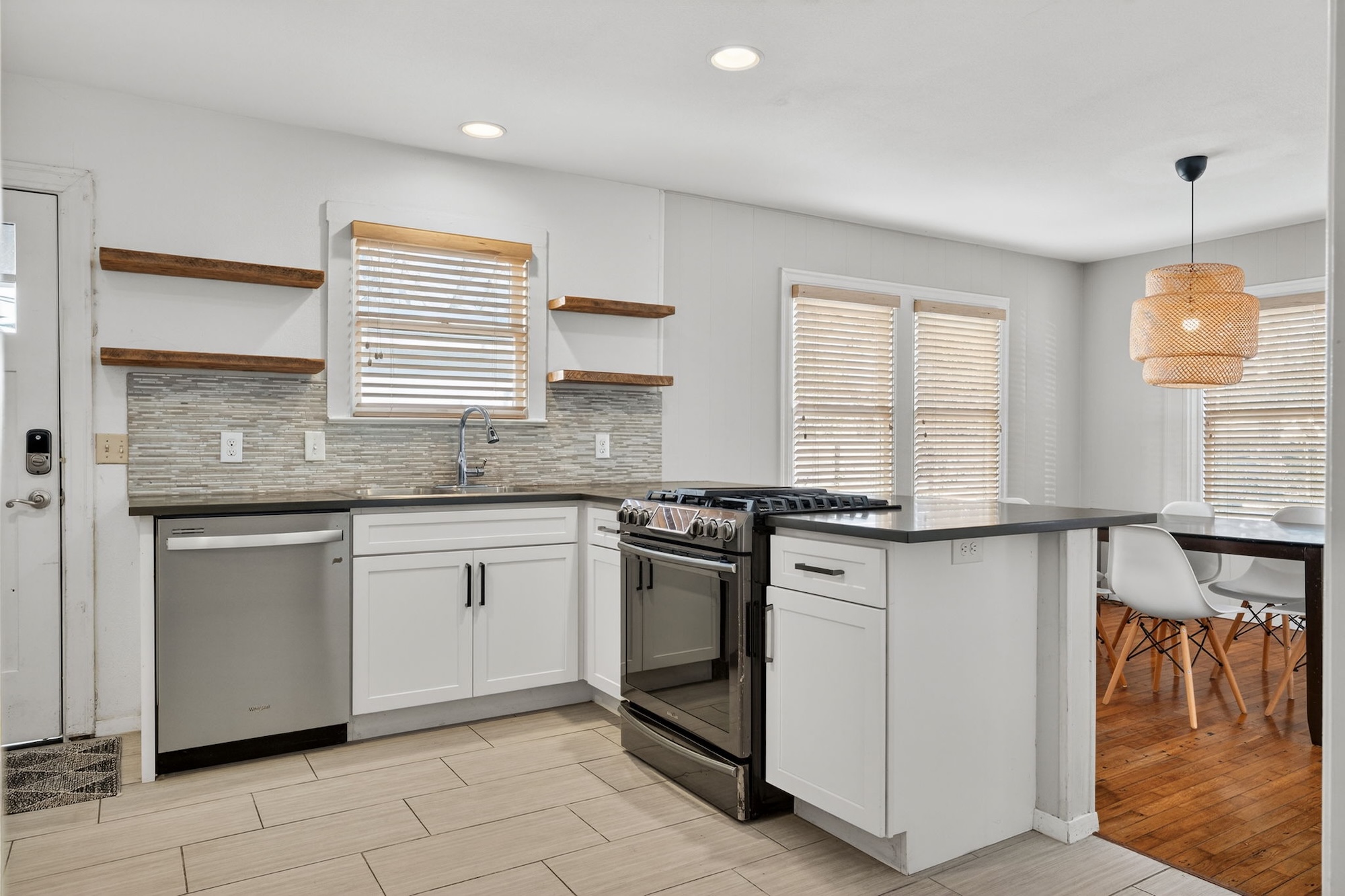 609 Fletcher Street Austin, TX 78704 - Photo 11 of 25 a kitchen with stainless steel appliances granite countertop a stove a sink and a microwave