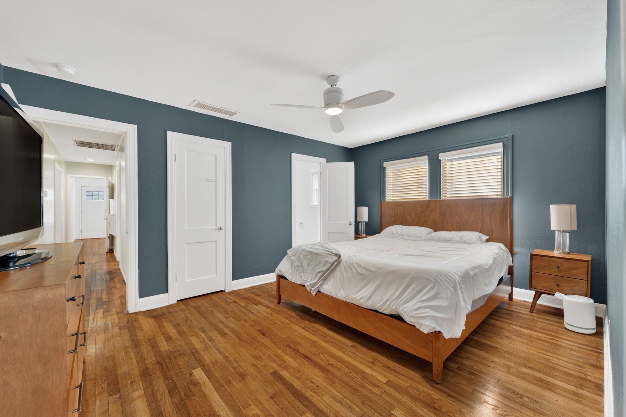 609 Fletcher Street Austin, TX 78704 - Photo 13 of 25 a bedroom with a bed and wooden floor