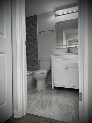 a bathroom with a toilet and a bathtub