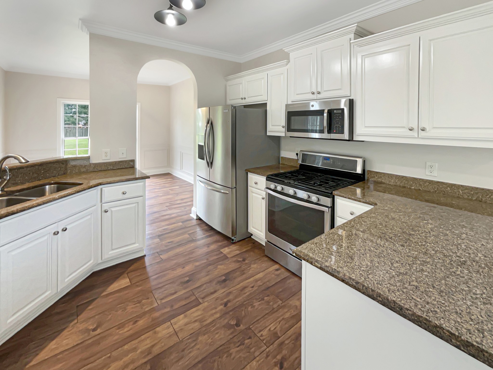 710 Heritage Road Lebanon, TN 37087 - Photo 6 of 23 a kitchen with stainless steel appliances granite countertop a stove a sink and a microwave