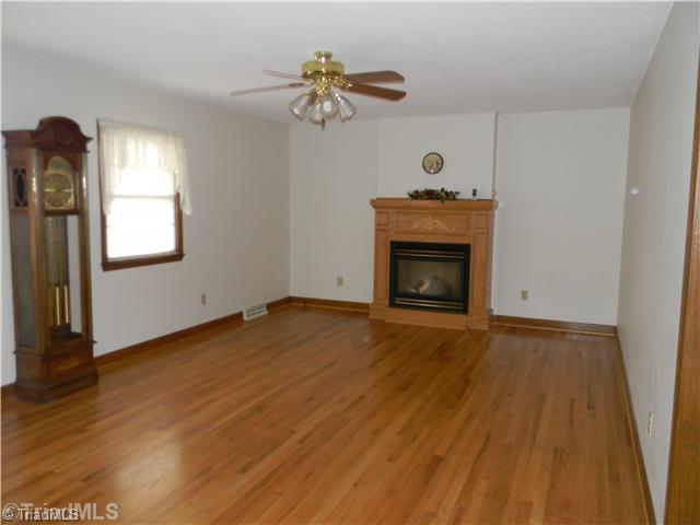 123 Aaron Road Elkin, NC 28621 - Photo 2 of 11 Living Room. Beautiful hardwood floors and gas logs in the living room.