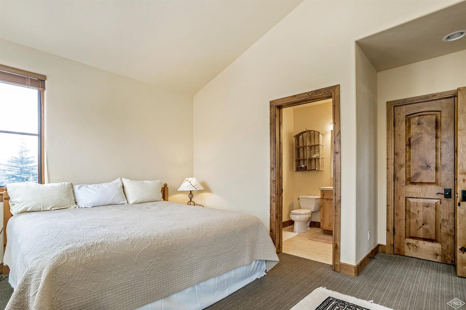 46 Hollis Lane Edwards, CO 81632 - Photo 22 of 25 a bedroom with a bed and wooden floor