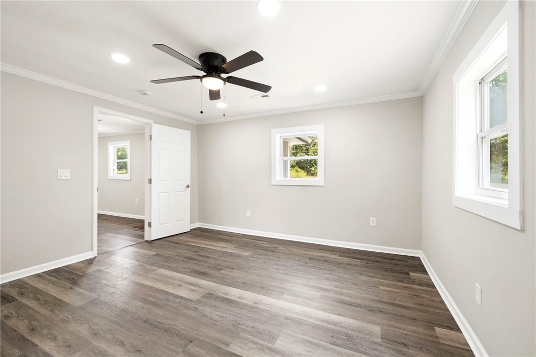 418 Old River Road Pelzer, SC 29669 - Photo 12 of 29 The generously sized primary bedroom features wood flooring, recessed lighting, and a ceiling fan.