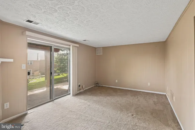 an empty room with glass door and glass door