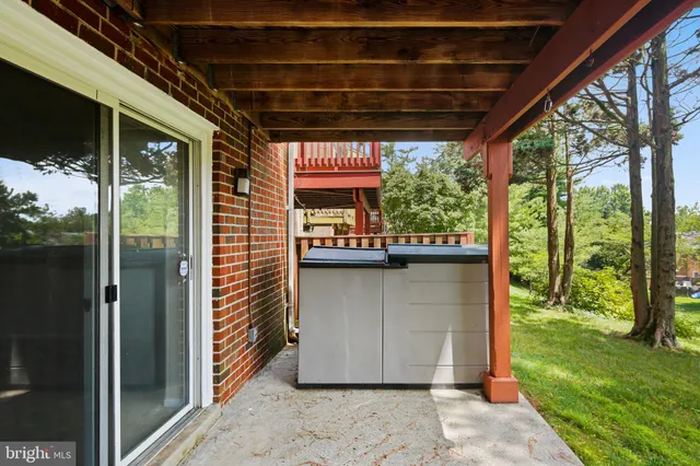 a view of a porch with a floor to ceiling window and wooden floor