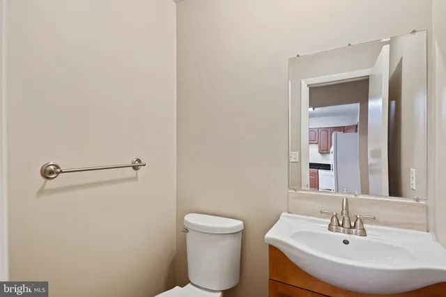 a bathroom with a toilet a sink and mirror