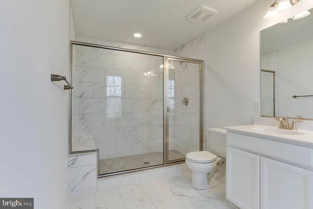 a bathroom with a shower a toilet and a sink