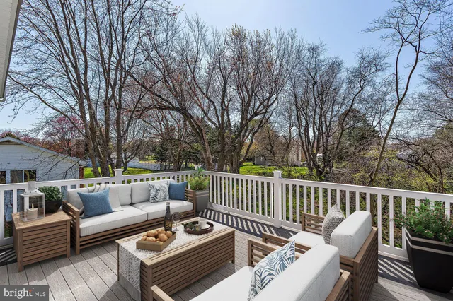 a view of a roof deck with couches and potted plants