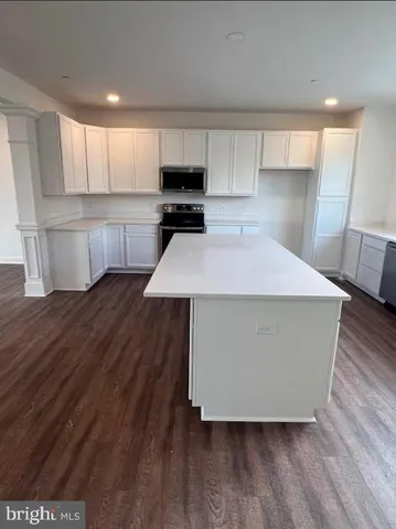 a room with wooden floors and wooden cabinets