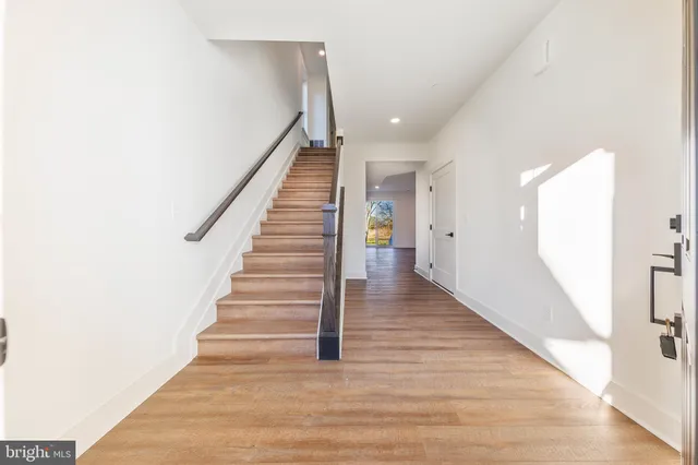 a spacious bedroom with a bed a couch and a potted plant