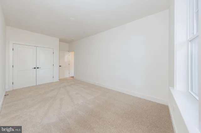 a view of an empty room with windows