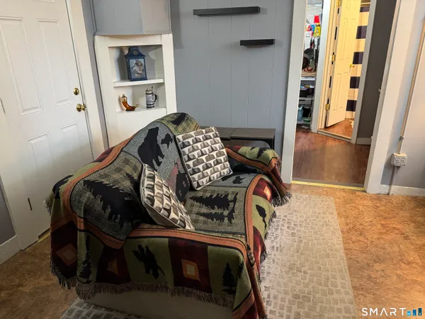 a bedroom with bed and a flat screen tv