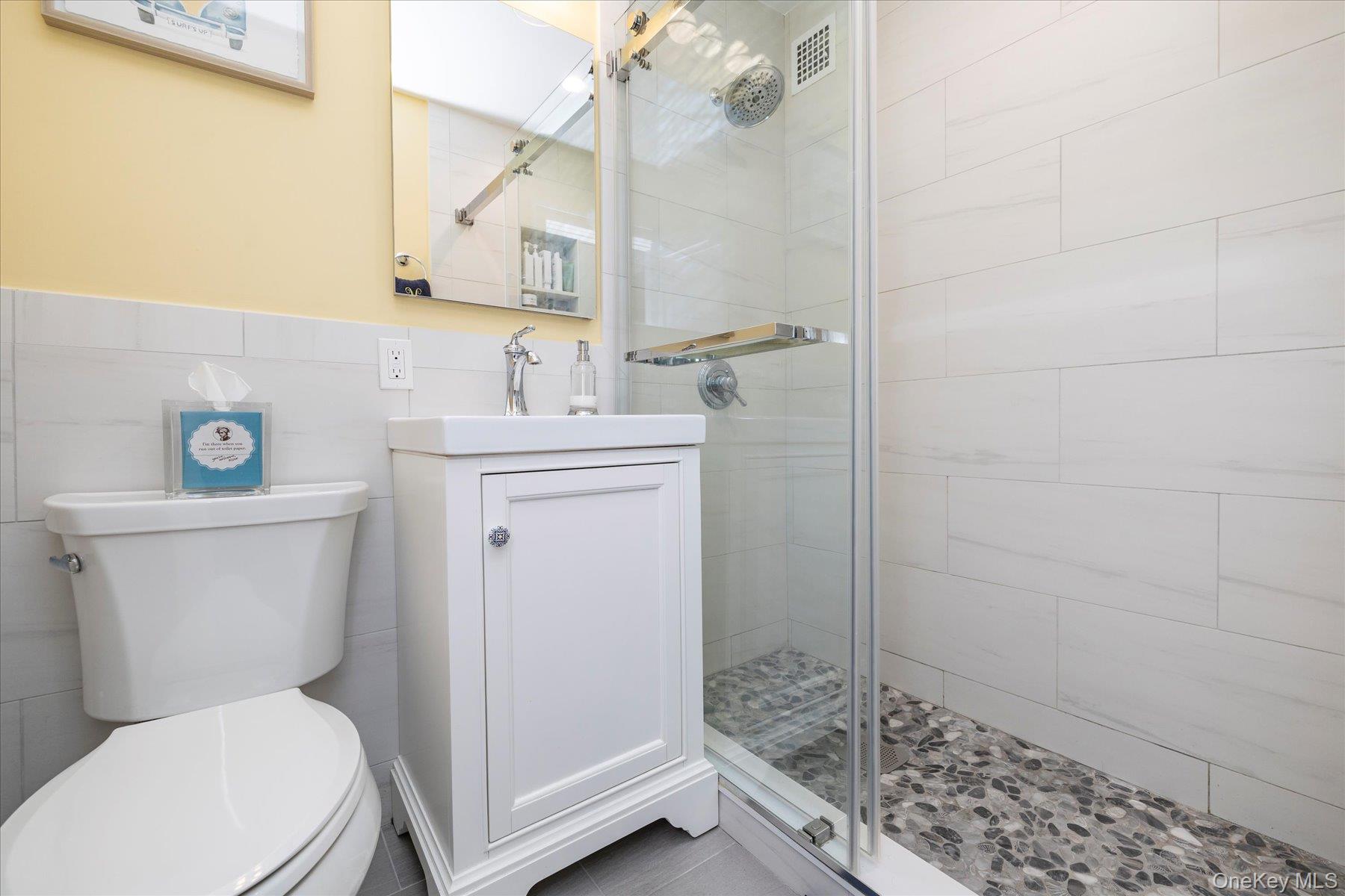 560 West Broadway, Unit 4R Long Beach, NY 11561 - Photo 13 of 26 a white toilet sitting next to a bathroom sink