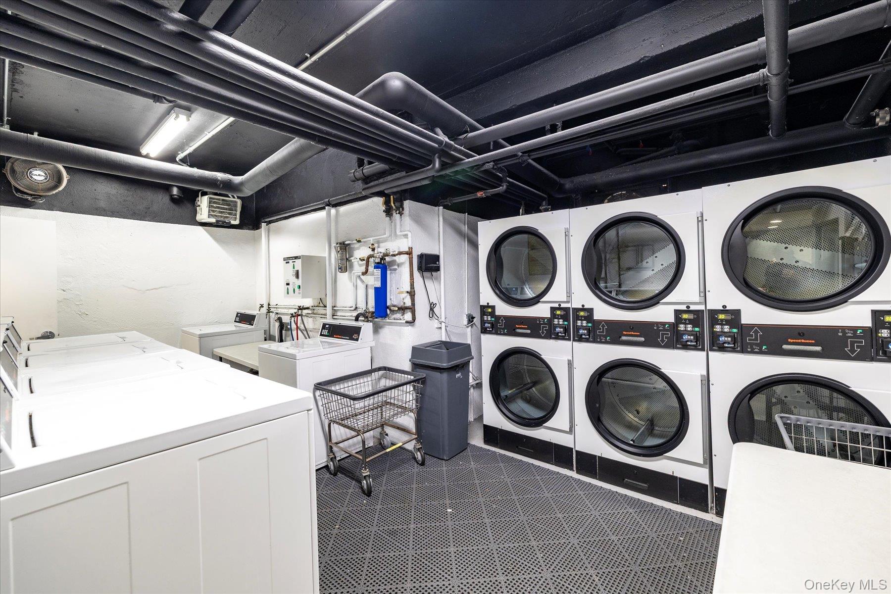 560 West Broadway, Unit 4R Long Beach, NY 11561 - Photo 17 of 26 a utility room with dryer washer and stair