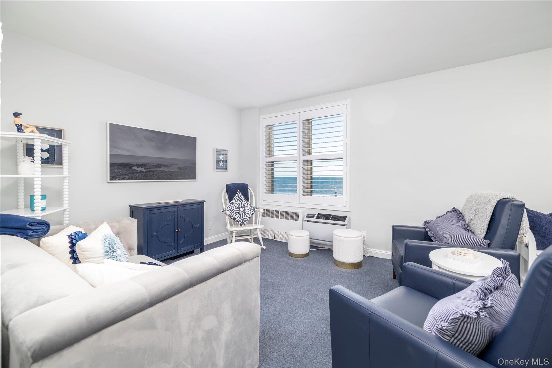 560 West Broadway, Unit 4R Long Beach, NY 11561 - Photo 4 of 26 a living room with furniture and a flat screen tv