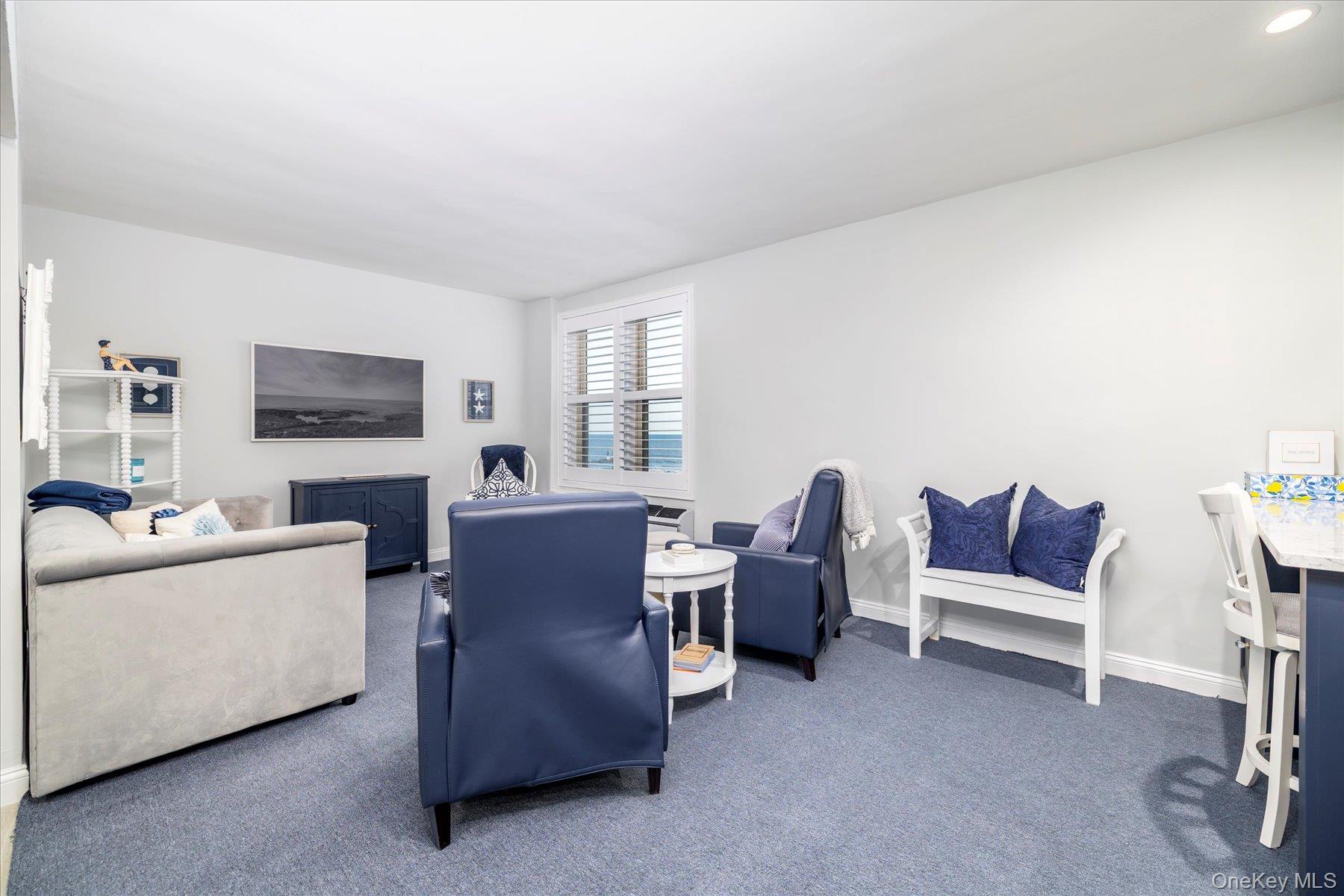 560 West Broadway, Unit 4R Long Beach, NY 11561 - Photo 5 of 26 a living room with furniture and a flat screen tv