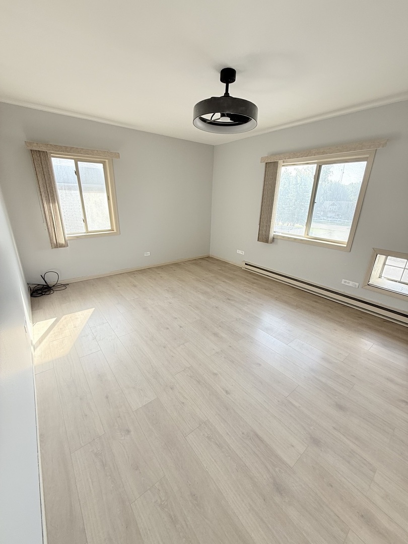 1925 Canal Street, Unit 3D Blue Island, IL 60406 - Photo 11 of 21 wooden floor in an empty room with a window
