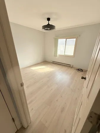 a view of an empty room and a window