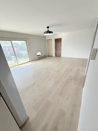 a view of an empty room with a window