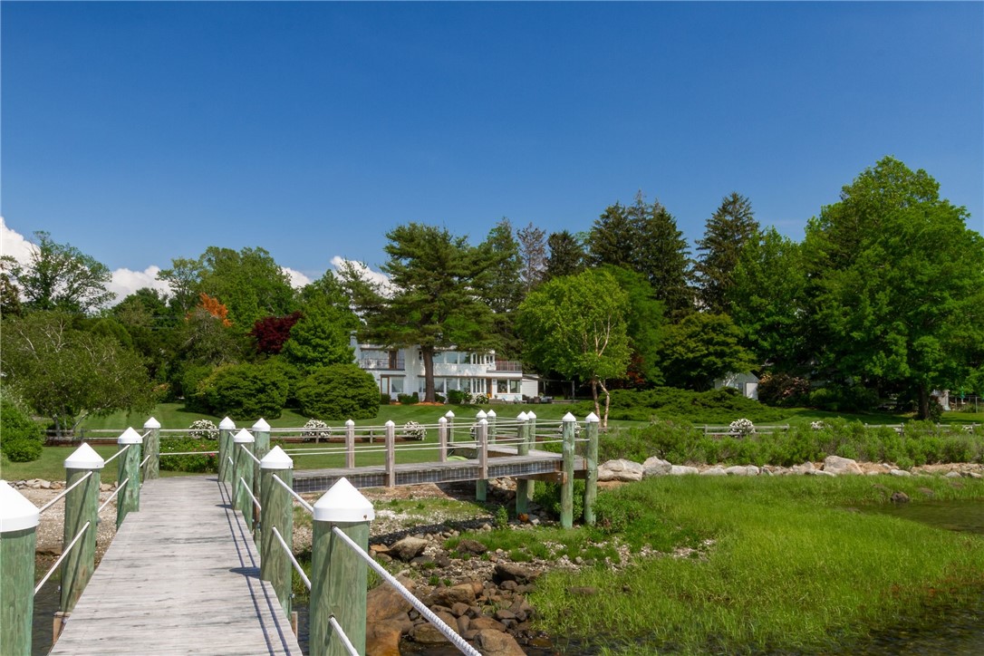 Sited on 1.8 lush acres, and 267 feet of private water frontage on Walker's Cove