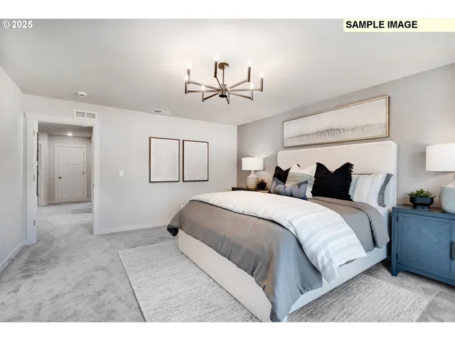 a spacious bedroom with a bed and a chandelier