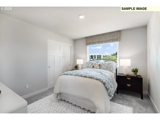 a bedroom with a bed and a large window