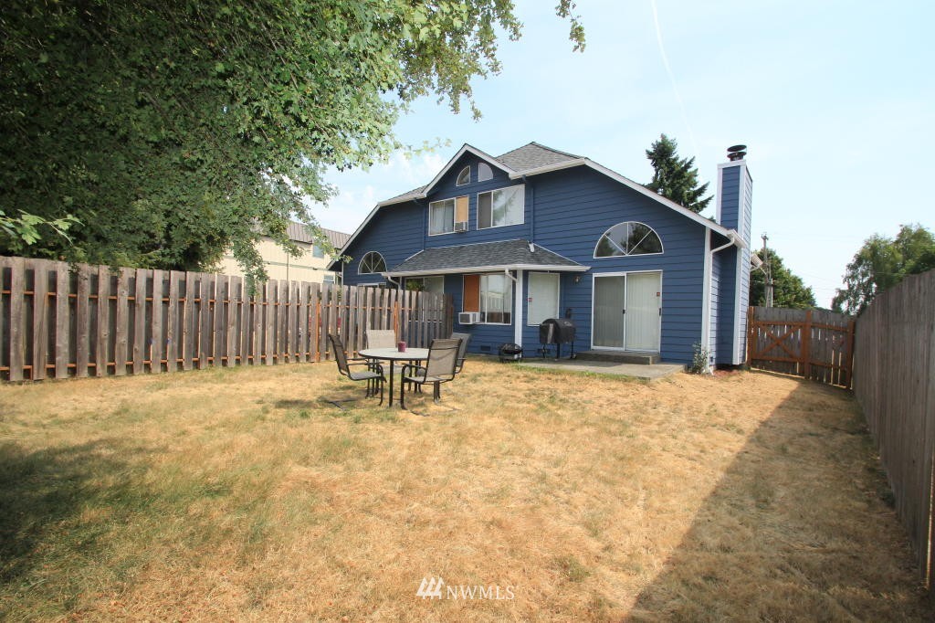 2900 Northeast 8th Street Renton, WA 98056 - Photo 22 of 25 a view of a house with wooden fence and a bench