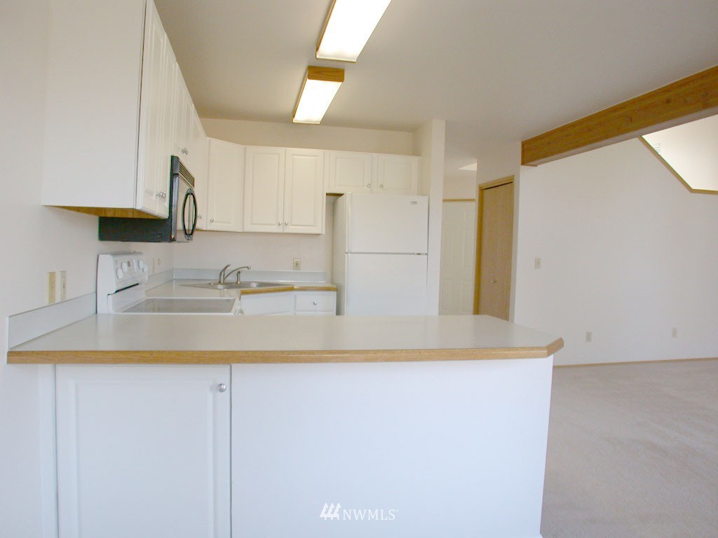 2900 Northeast 8th Street Renton, WA 98056 - Photo 6 of 25 a kitchen with a sink and a refrigerator
