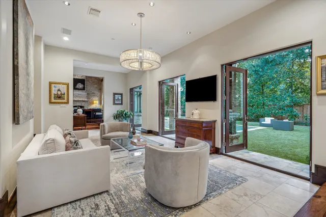 a living room with fireplace furniture and a large window
