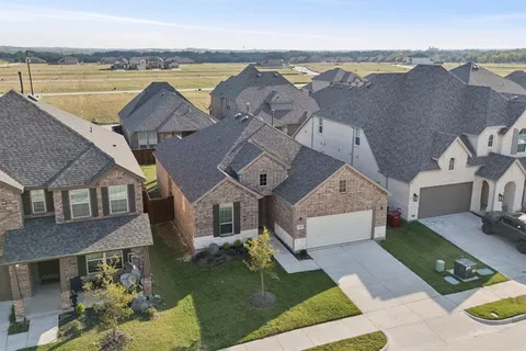 an aerial view of a house with parking space
