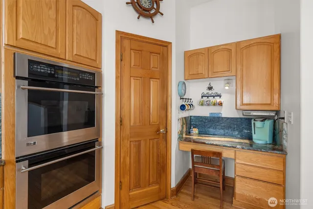 a kitchen with granite countertop cabinets stainless steel appliances and a counter space