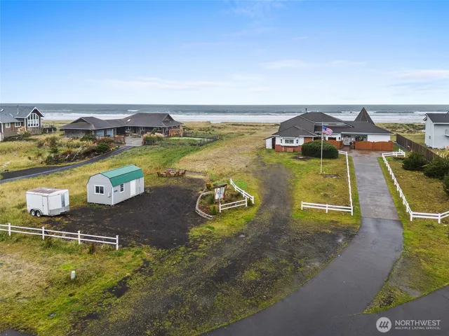 an aerial view of a house with swimming pool and ocean view