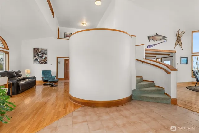 a view of a livingroom with furniture and staircase