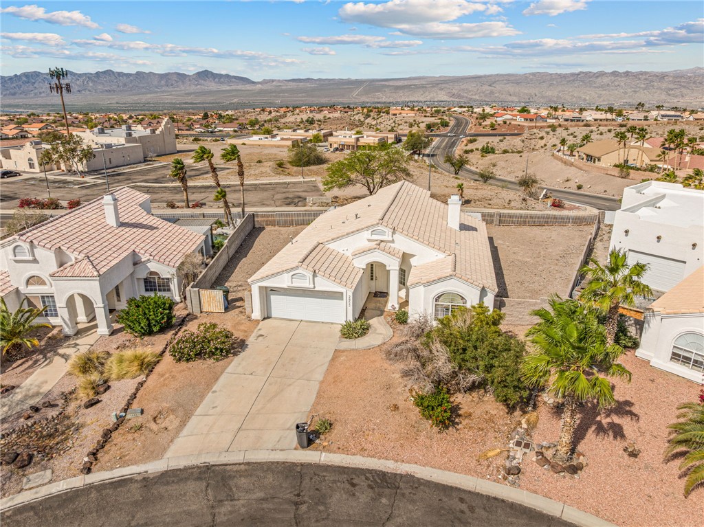 2853 Winchester Road Bullhead City, AZ 86442 - Photo 39 of 40 This property features a single-story residence with an attached two-car garage and a paved driveway