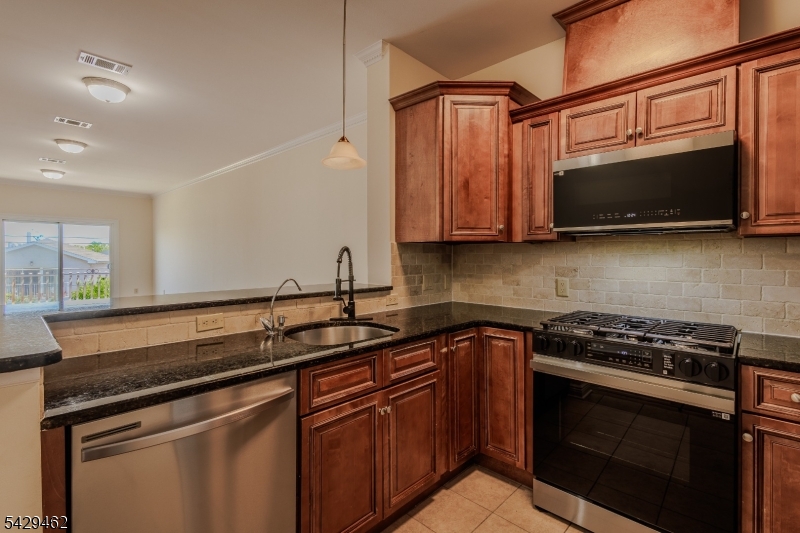 29 Freeman Street, Unit D2 Newark, NJ 07105 - Photo 1 of 29 a kitchen with stainless steel appliances granite countertop a sink stove and microwave