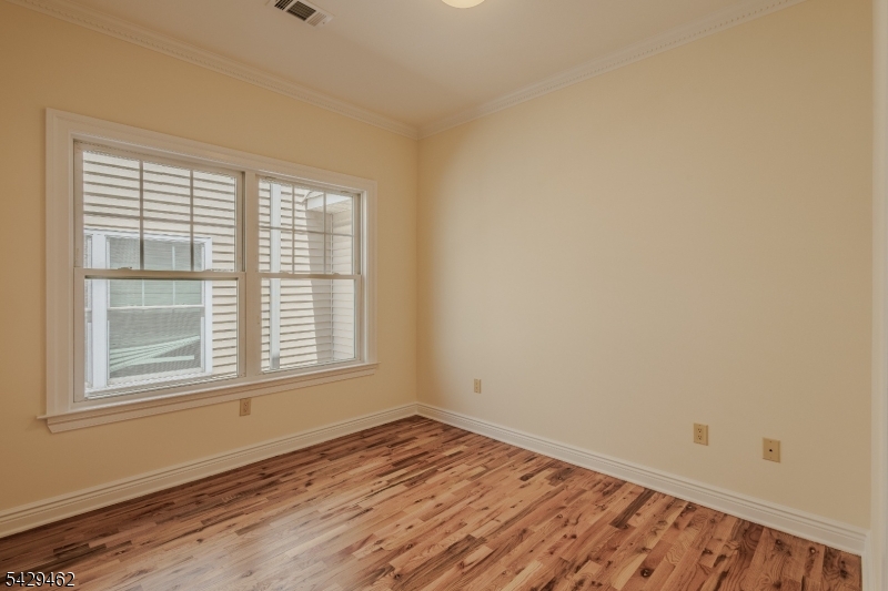29 Freeman Street, Unit D2 Newark, NJ 07105 - Photo 12 of 29 an empty room with wooden floor and windows