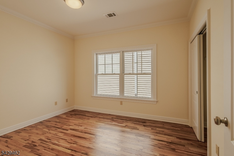 29 Freeman Street, Unit D2 Newark, NJ 07105 - Photo 14 of 29 an empty room with wooden floor and windows
