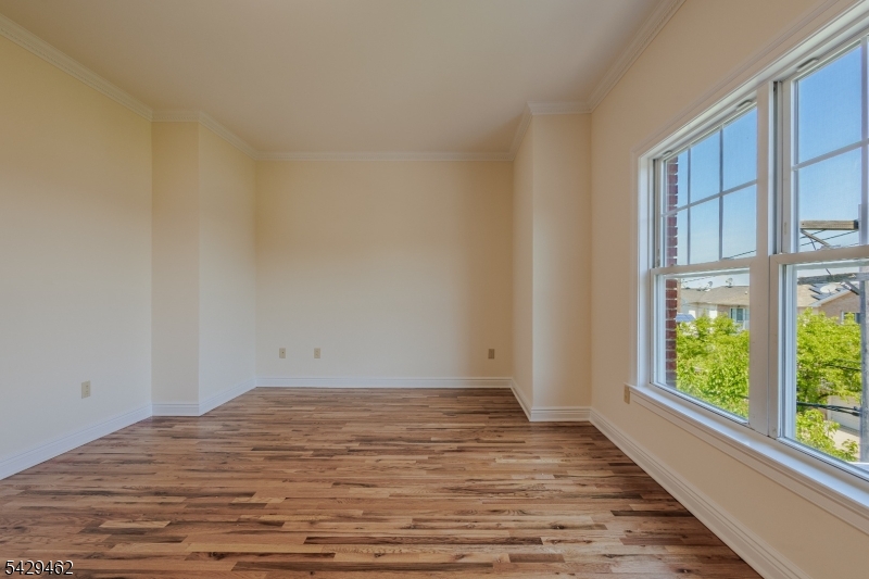 29 Freeman Street, Unit D2 Newark, NJ 07105 - Photo 15 of 29 a view of empty room with wooden floor and fan