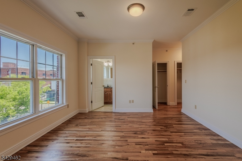 29 Freeman Street, Unit D2 Newark, NJ 07105 - Photo 17 of 29 a view of an empty room with wooden floor and a window