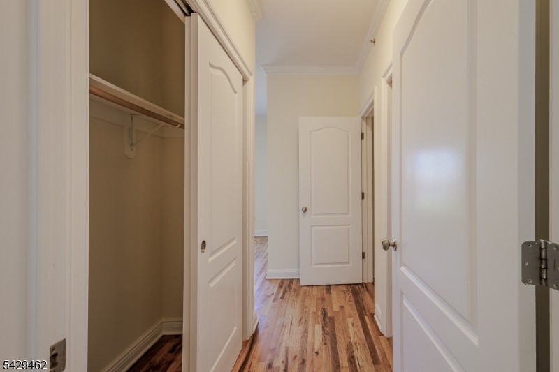 29 Freeman Street, Unit D2 Newark, NJ 07105 - Photo 19 of 29 a view of a hallway with wooden floor and closet