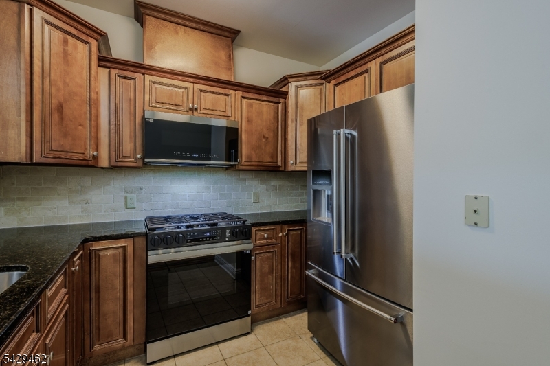 29 Freeman Street, Unit D2 Newark, NJ 07105 - Photo 2 of 29 a kitchen with stainless steel appliances granite countertop a stove microwave and refrigerator