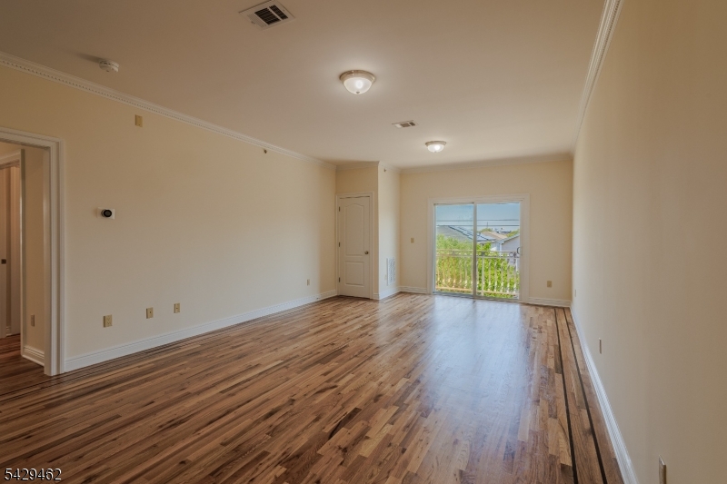 29 Freeman Street, Unit D2 Newark, NJ 07105 - Photo 7 of 29 a view of empty room with wooden floor and fan