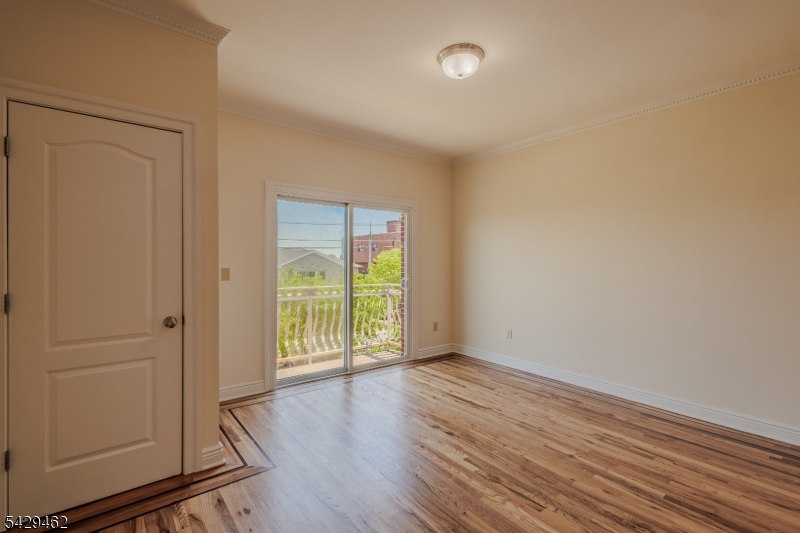 29 Freeman Street, Unit D2 Newark, NJ 07105 - Photo 8 of 29 an empty room with wooden floor and windows