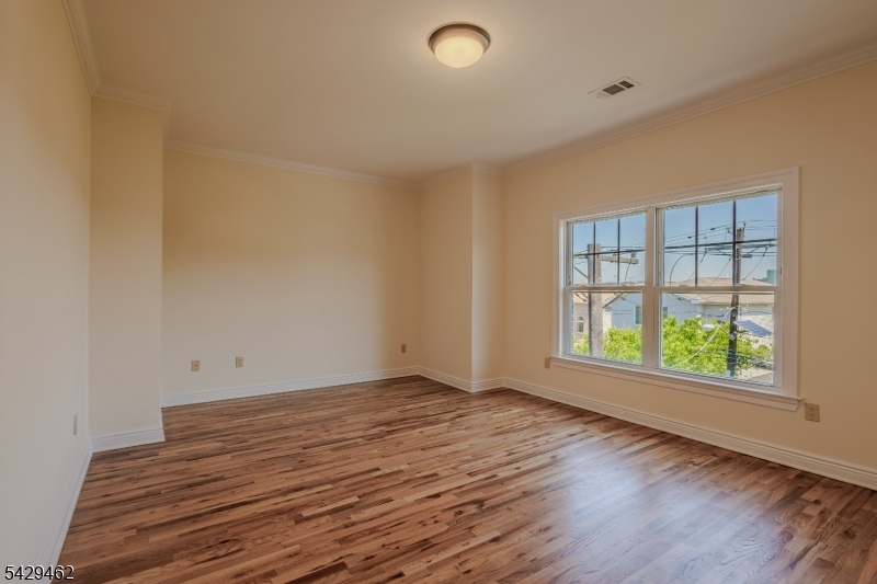 29 Freeman Street, Unit D2 Newark, NJ 07105 - Photo 10 of 29 an empty room with wooden floor and windows