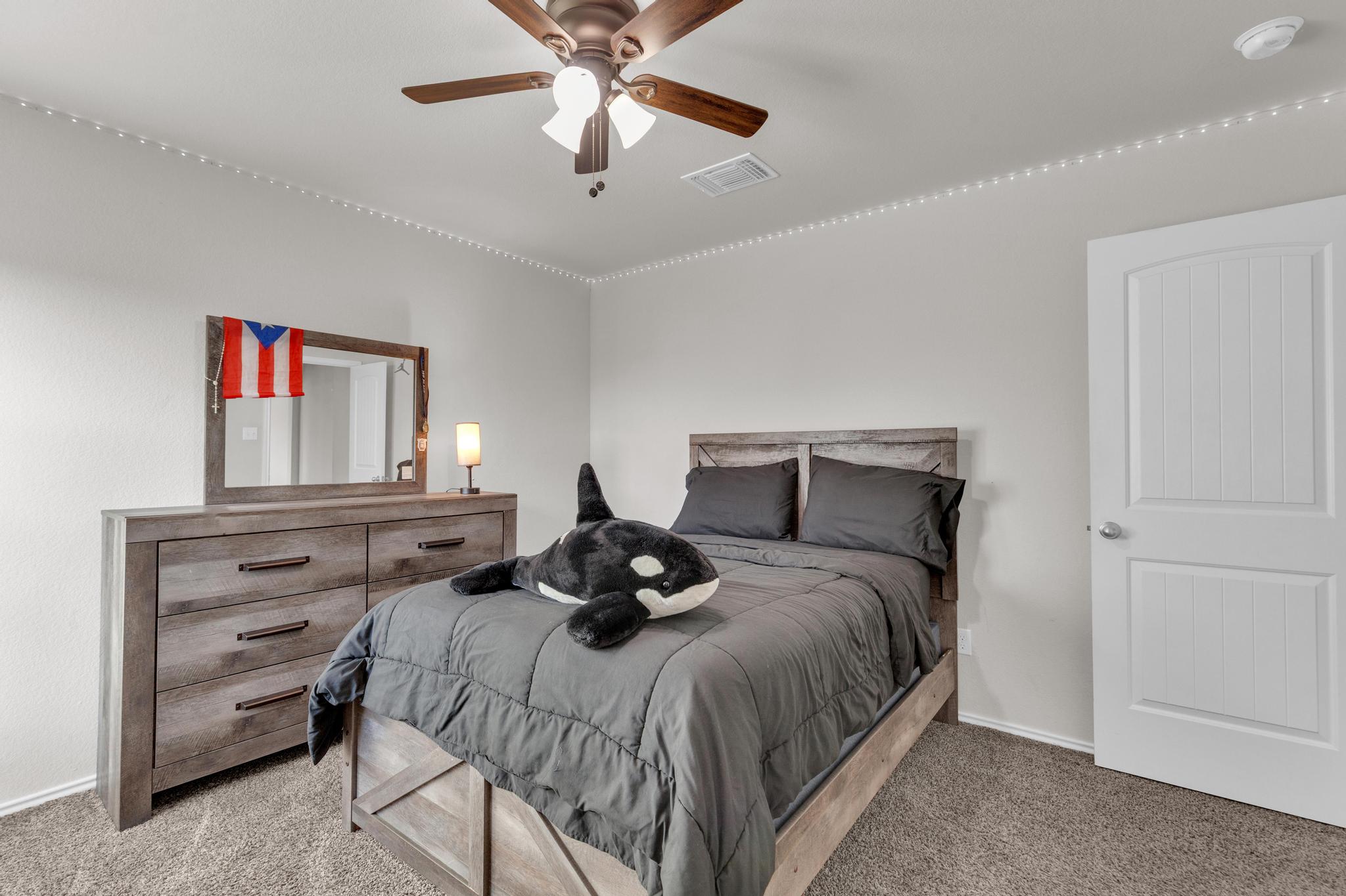 104 Uncle Billy Way Jarrell, TX 76537 - Photo 27 of 38 A well-lit bedroom provides comfortable living with soft carpet and a convenient ceiling fan.