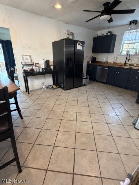 1148 Riverside Avenue Wellsville, OH 43968 - Photo 6 of 14 Kitchen with refrigerator, ceiling fan, dishwasher, light tile patterned floors, and a textured ceiling