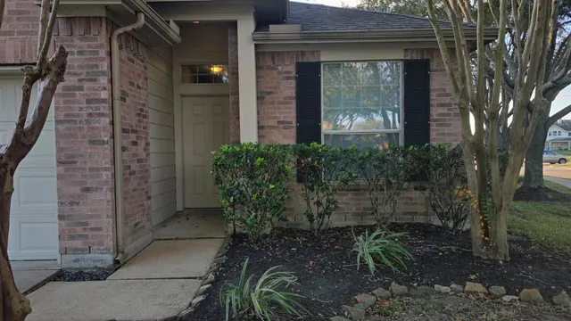 a view of a brick house with a yard
