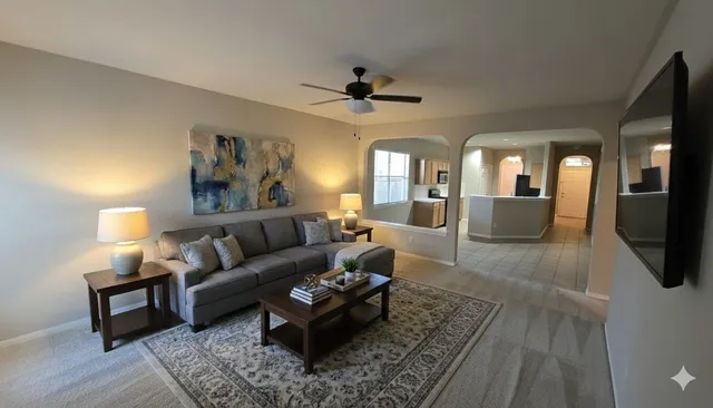 a living room with furniture and a chandelier