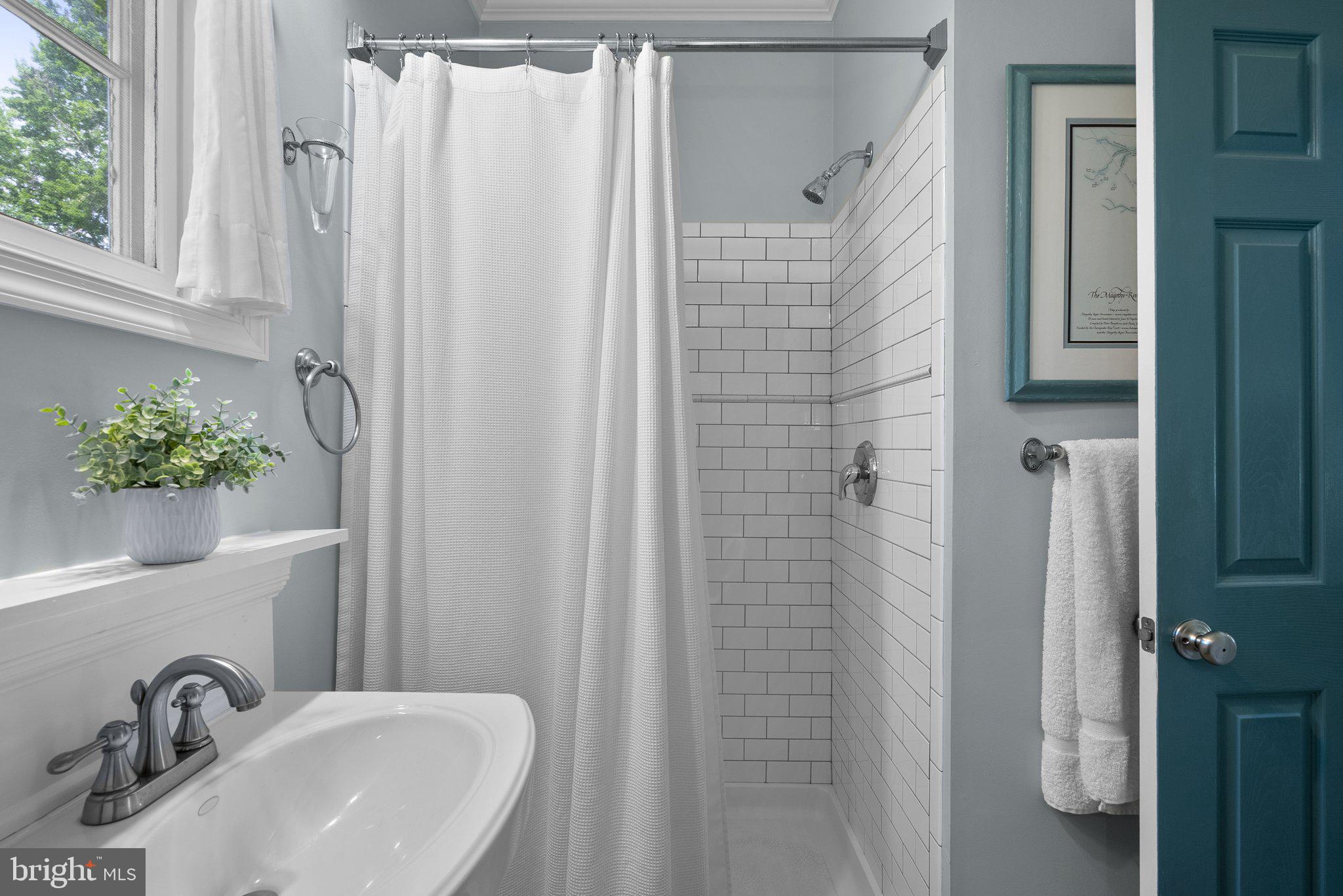 743 Rolling View Drive Annapolis, MD 21409 - Photo 31 of 100 a bathroom with shower a sink and a mirror