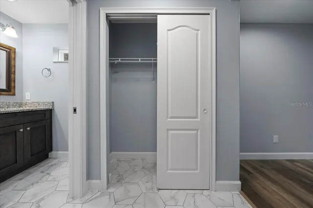 a bathroom with a sink vanity and mirror